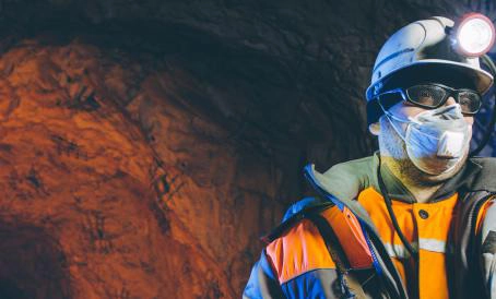 Miner in shaft depicting SaniChem SA's role in mining mosquito and environment control.